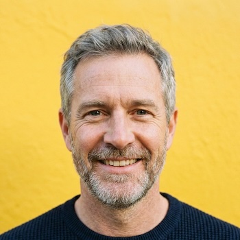 Authentic headshot of a smiling man providing recovery community support
